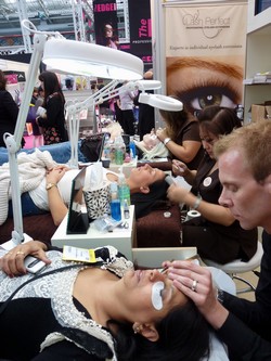 Volunteers having lashes applied at Olympia